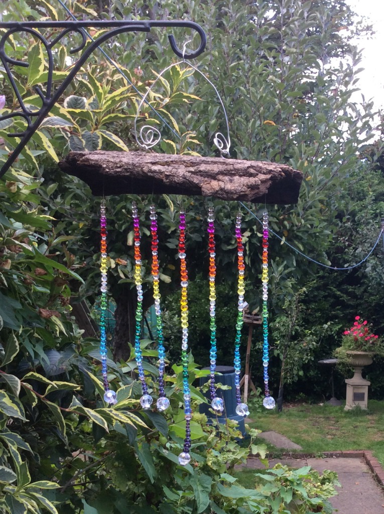 My homemade sun catcher, using rainbow coloured glass beads threaded and suspended from a piece of bark.